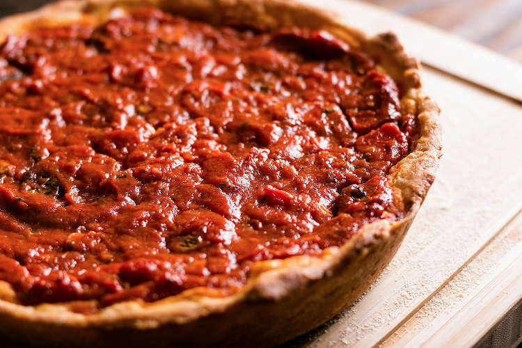 close-up of deep dish pizza on a table