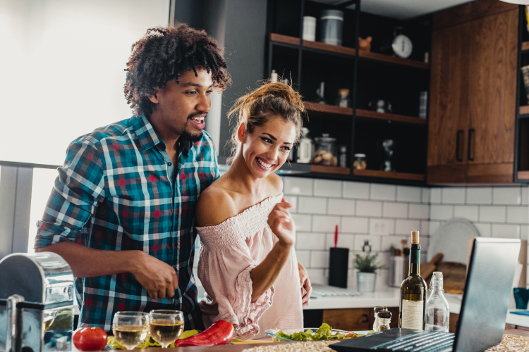 young couple taking an online cooking class