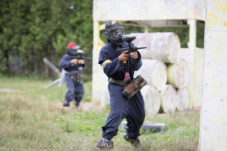 a man in protective gear playing paintball