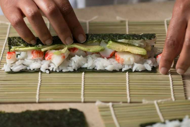 rolling a sushi roll