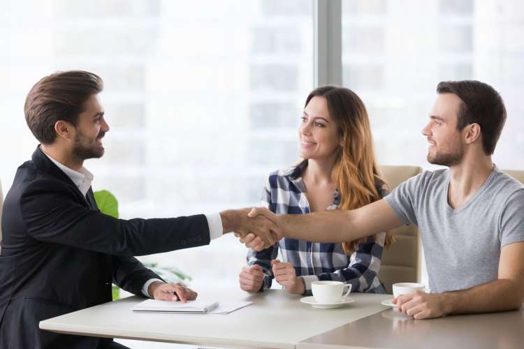 clients shaking hands with an employee