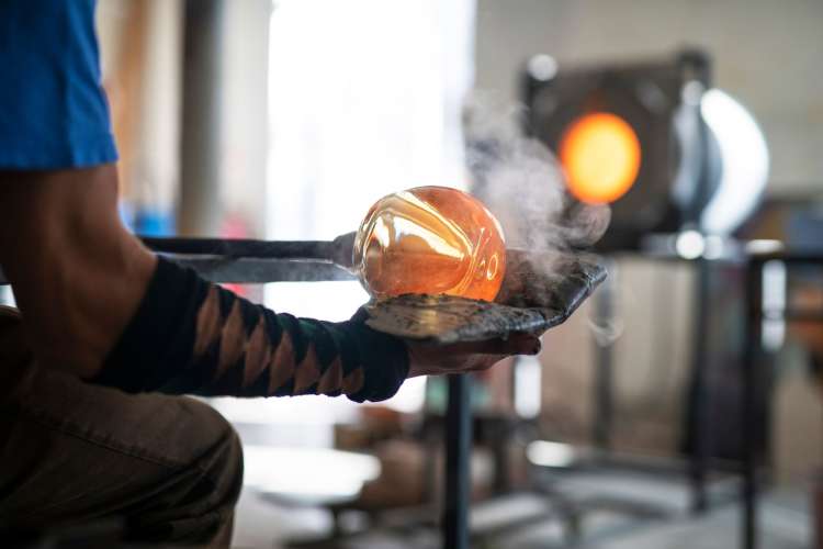 a man doing glass blowing