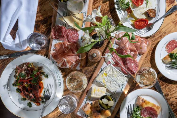 a table laid with charcuterie and an array of Italian dishes