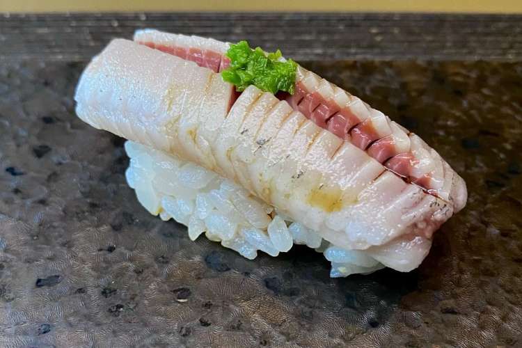 a piece of iwashi, or sardine, nigiri