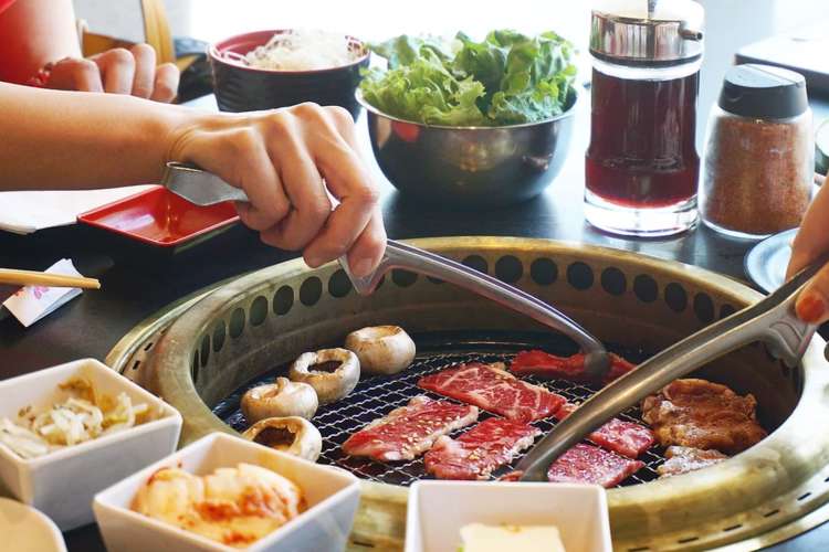 People serving themselves Korean BBQ