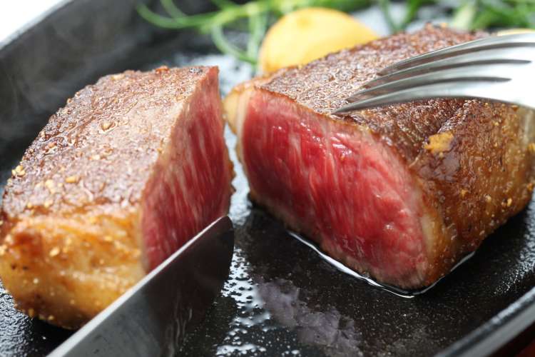 a knife cutting into a wagyu steak