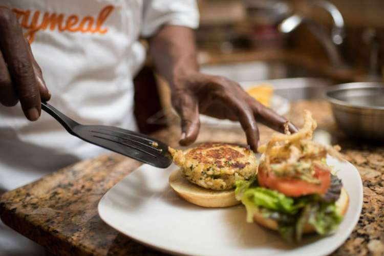 a chef preparing a burger