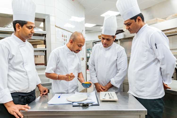 executive chef chatting with sous chef about menu