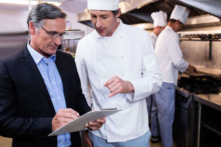 executive chef interacting with restaurant manager