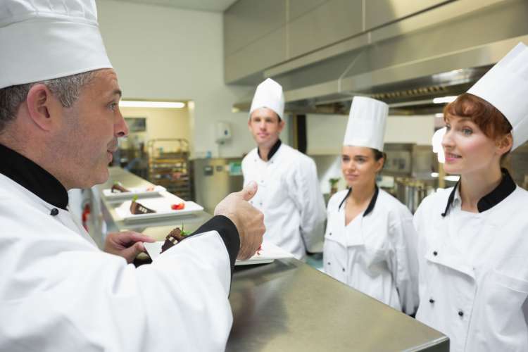 chef speaking to kitchen staff