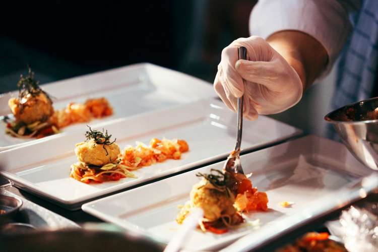 a chef garnishing a dish