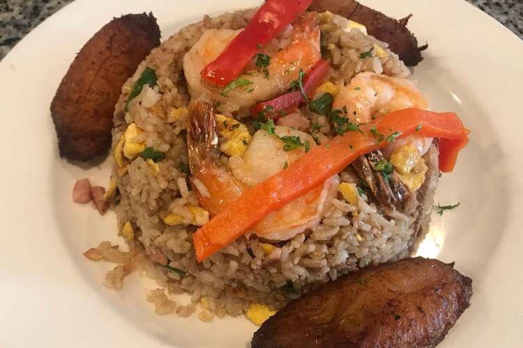 a plate of fried rice with shrimp