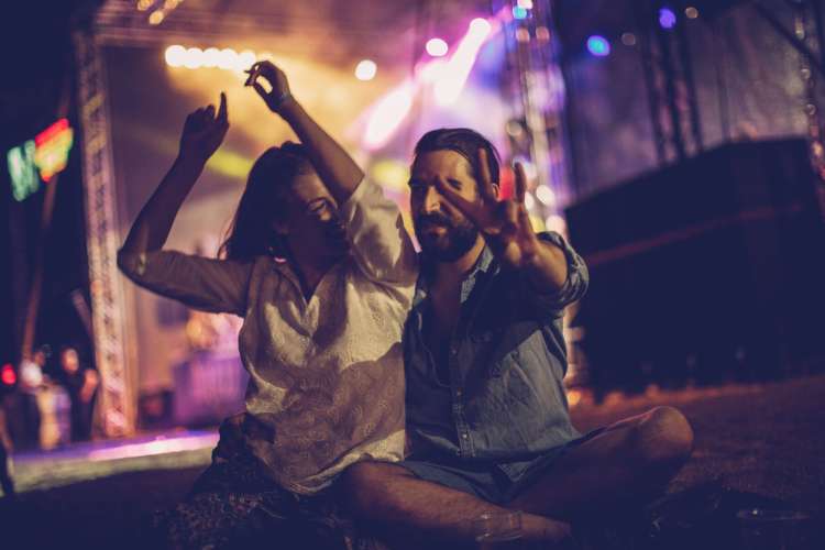 a couple enjoy an outdoor concert at night