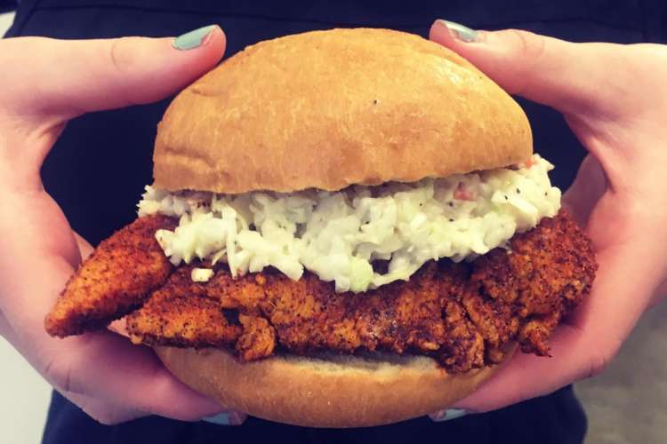 a hot chicken sandwich with coleslaw