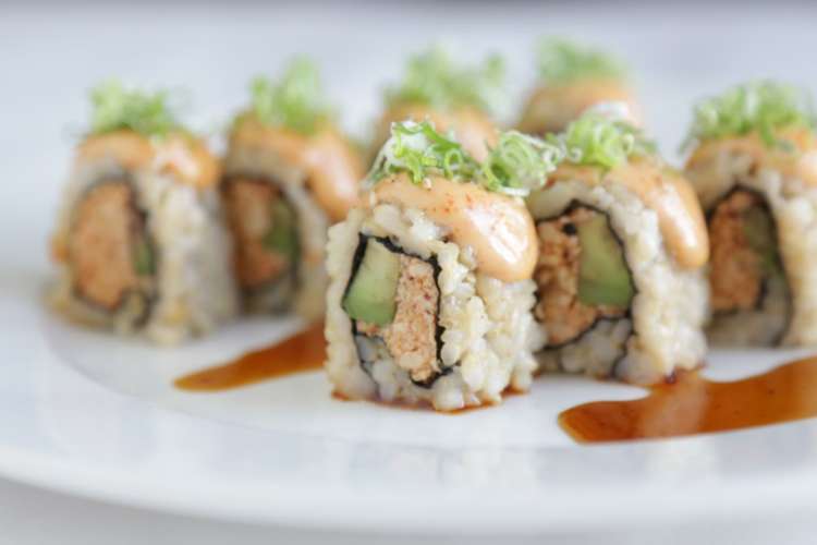 a beautifully plated vegan sushi with avocado