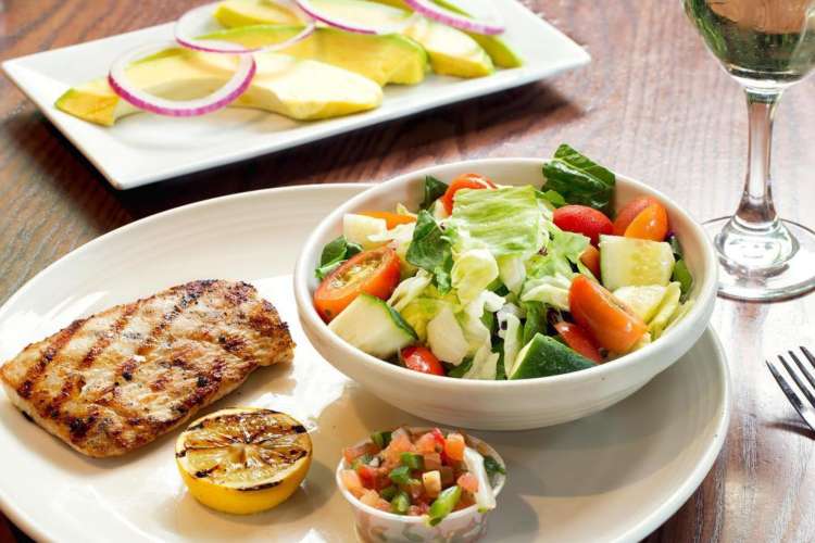 a healthy lunch of blackened fish, salad, and light sides