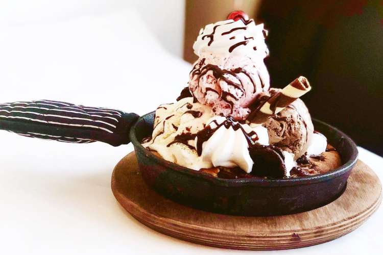 a skillet filled with a cookie and ice cream sundae