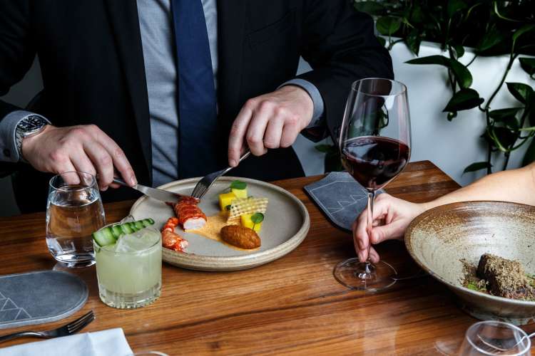 a couple enjoying a lavish meal with wine