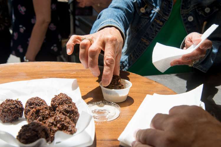 enjoying food on a walking food tour