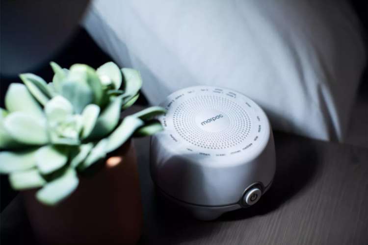 a white noise machine on a night stand