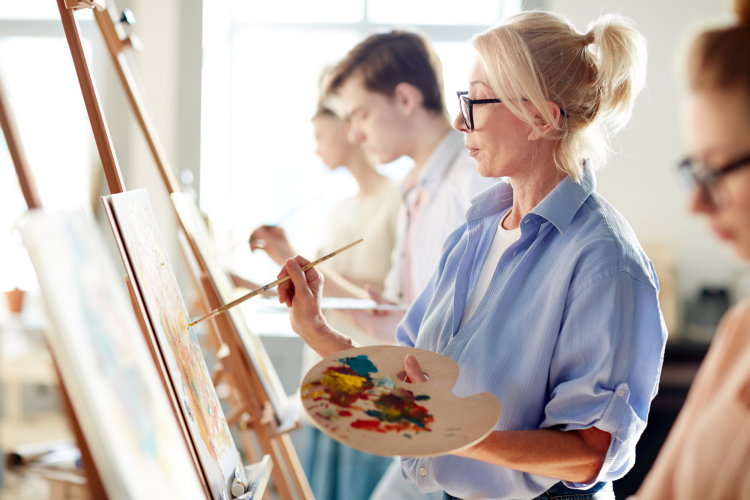 woman painting during an art class