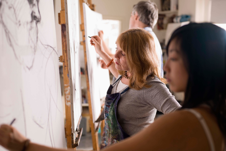 Three people taking an art class as a team building activity in Los Angeles
