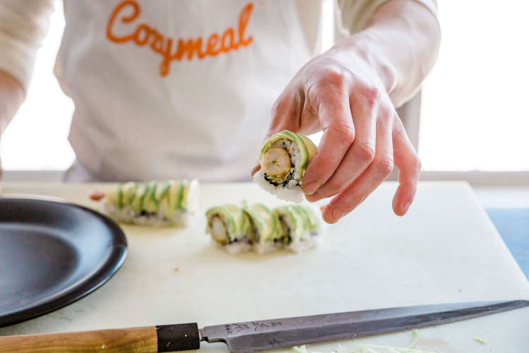 chef holding up a uramaki roll