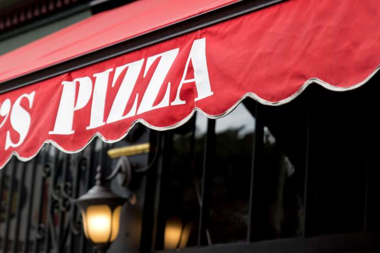 pizzeria sign on a walking food tour of chicago