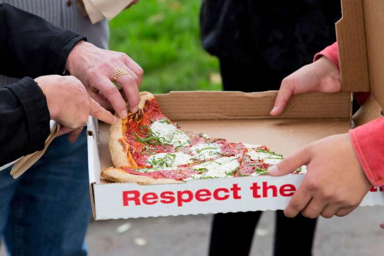 enjoying pizza on a food tour