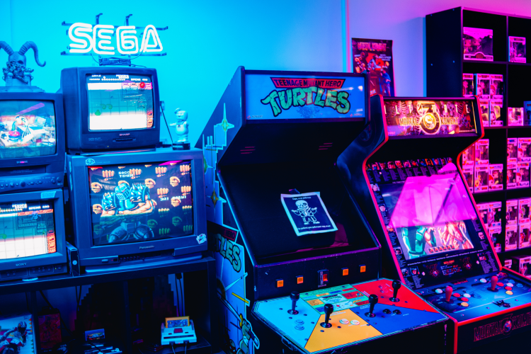 classic sega and ninja turtle arcade games under neon lights