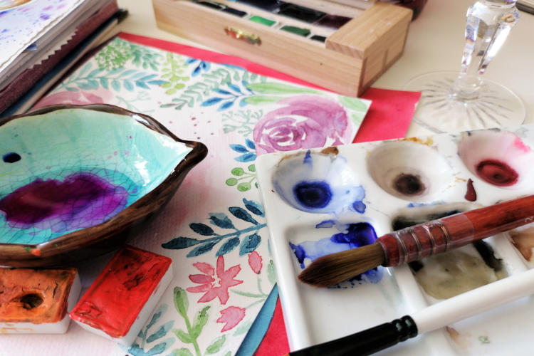 watercolor paints with paintings of flowers