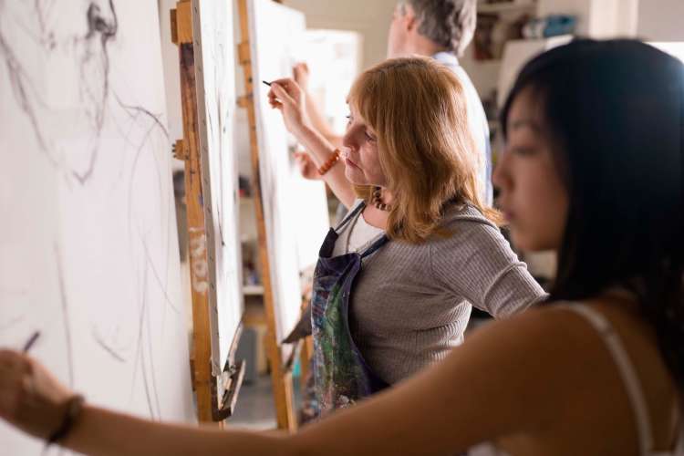 adults taking a drawing class