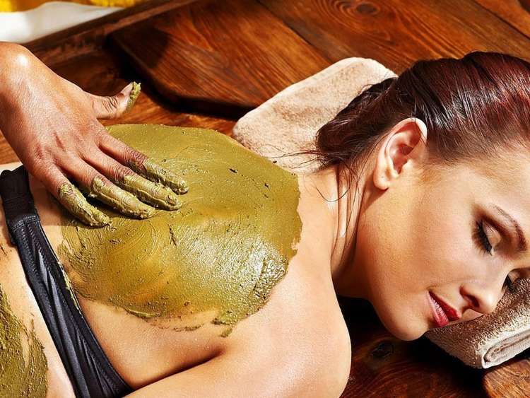 woman at a spa getting a mud mask