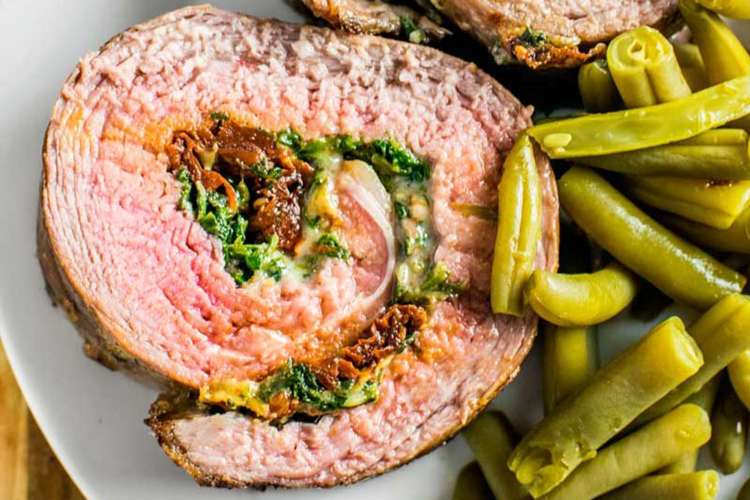 baked stuffed flank steak is filled with a creamy spinach, mozzarella and sun-dried tomato mix