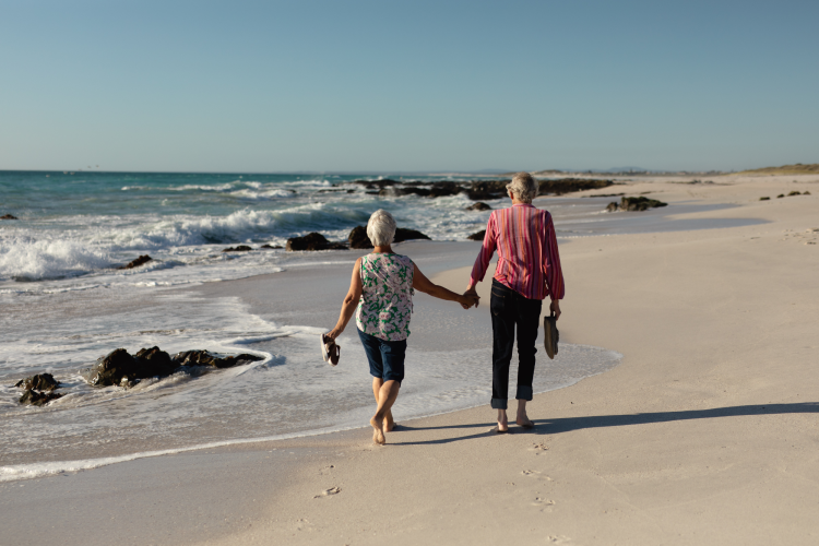 couple walking hand in hand on beach