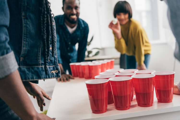 friends playing beer pong