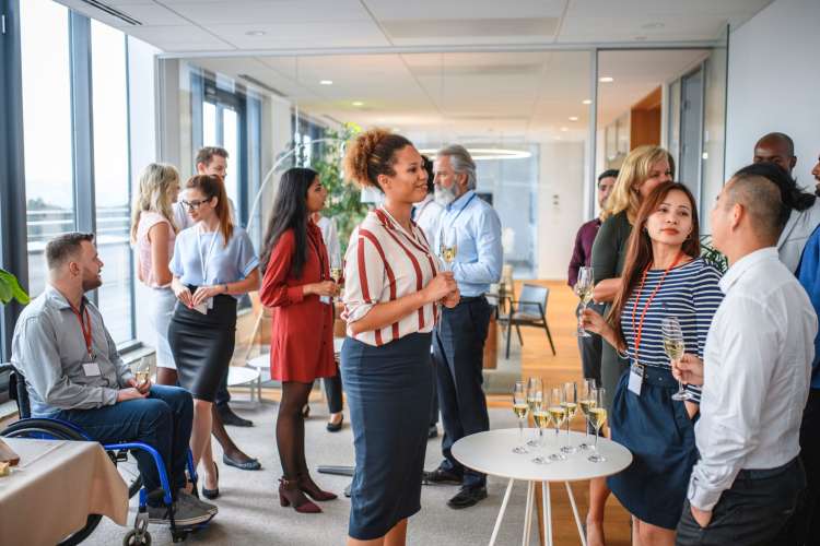 A staff office party, with co-workers chatting together