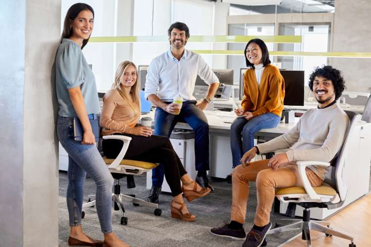 five professionals at work smiling