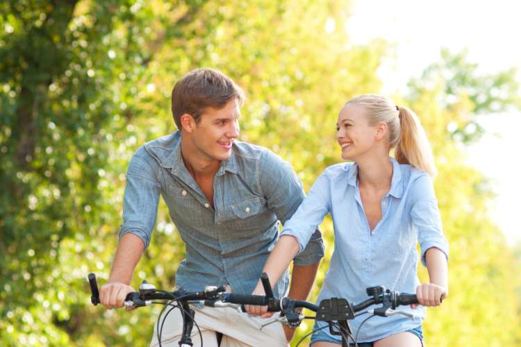 young couple taking a bike ride outdoors