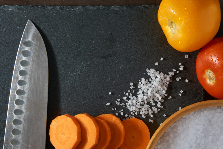 chef knife with sliced carrots