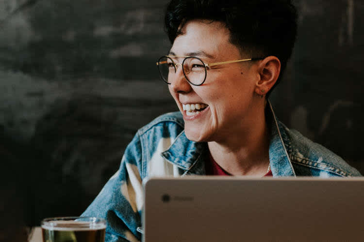 woman laughing during a virtual happy hour