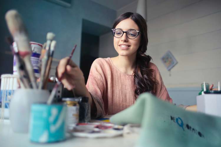 young woman painting a homemade birthday gift