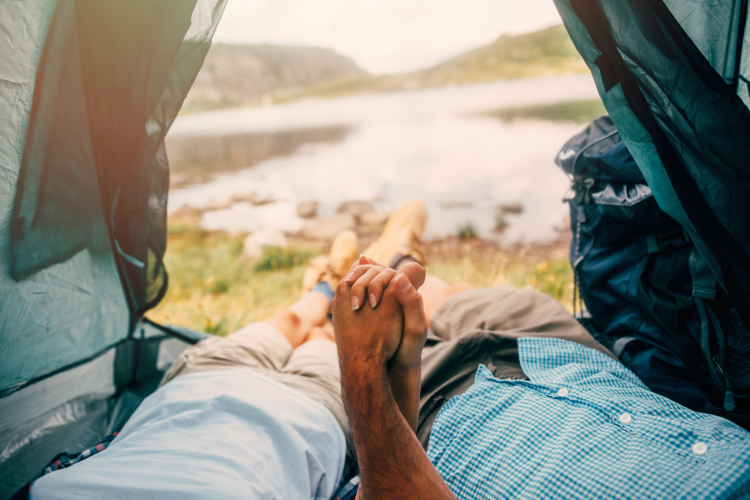 couple holding hands in a tent