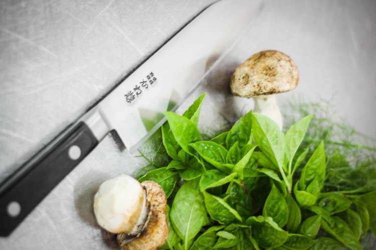 japanese chef's knife with mushrooms and thai basil