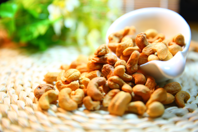 cashews in a wooden scoop