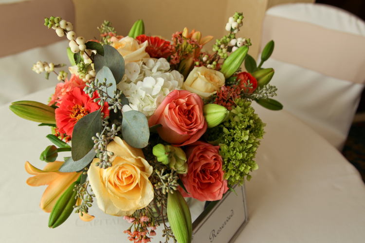 flower centerpiece on a table in a baquet hall