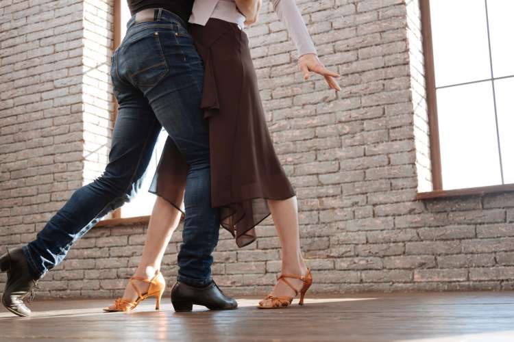 couple salsa dancing in a ballroom