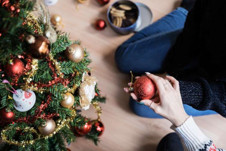 couple decorating their tree for christmas