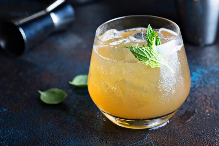 apple cider cocktail with mint garnish