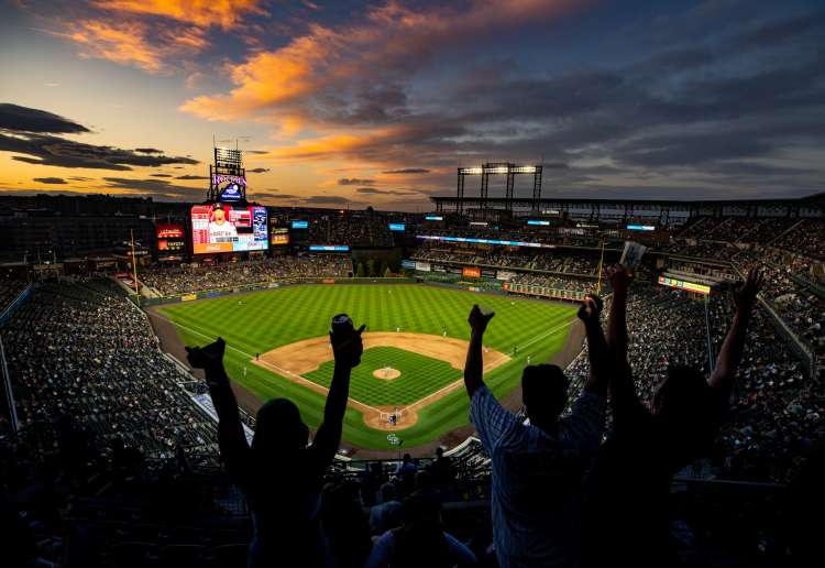 coors field lit up at night for a baseball game